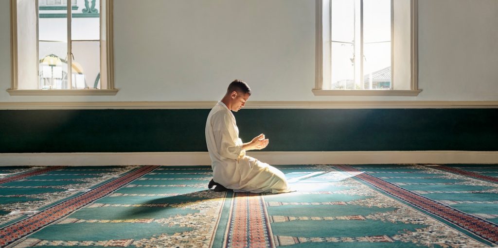 Muslim pray, hope or hands in prayer on carpet for peace, gratitude or support to Allah in holy tem